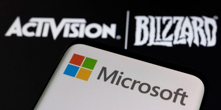 Microsoft logo is seen on a smartphone placed on displayed Activision Blizzard logo in this illustration taken January 18, 2022. REUTERS/Dado Ruvic/Illustration